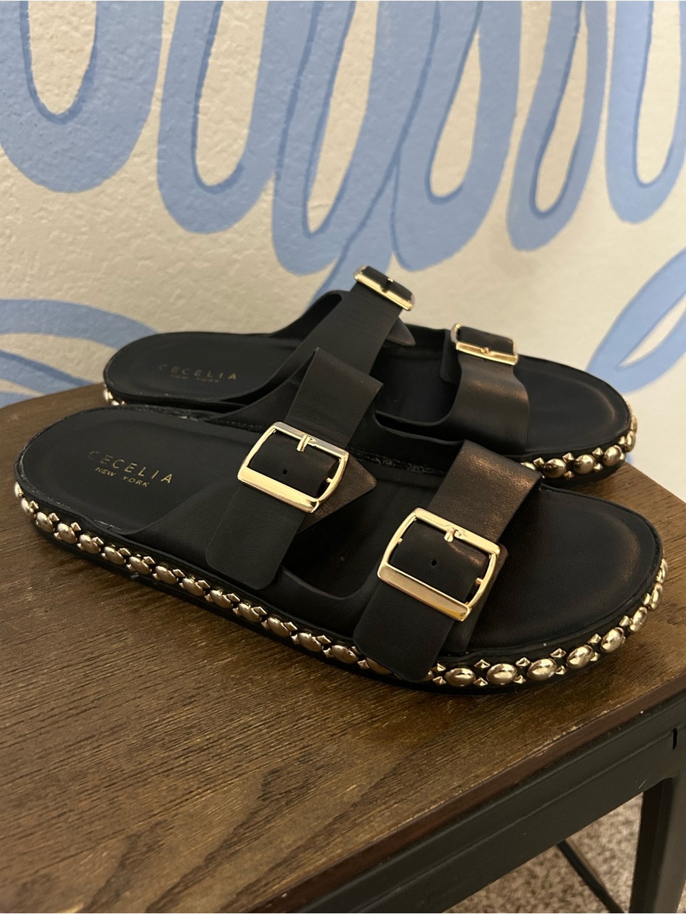CECILIA NEW YORK Black Slide Sandals with Gold Buckles and Stud Trim